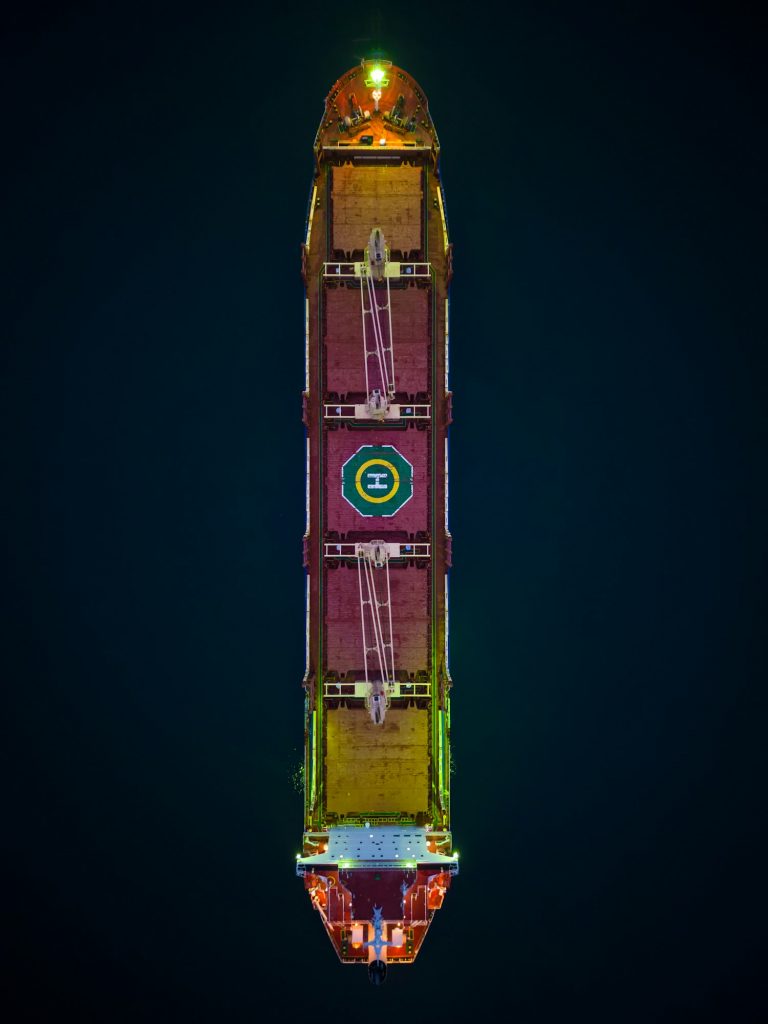 Aerial view cargo bulk carrier ship on the sea at night