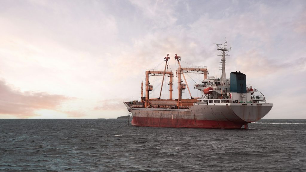 Bulk carrier at sunset on sea